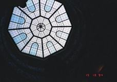 Oval stairs in dark with glass partition (vitrage) above