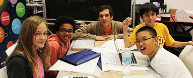 Participants collaborating around a classroom table