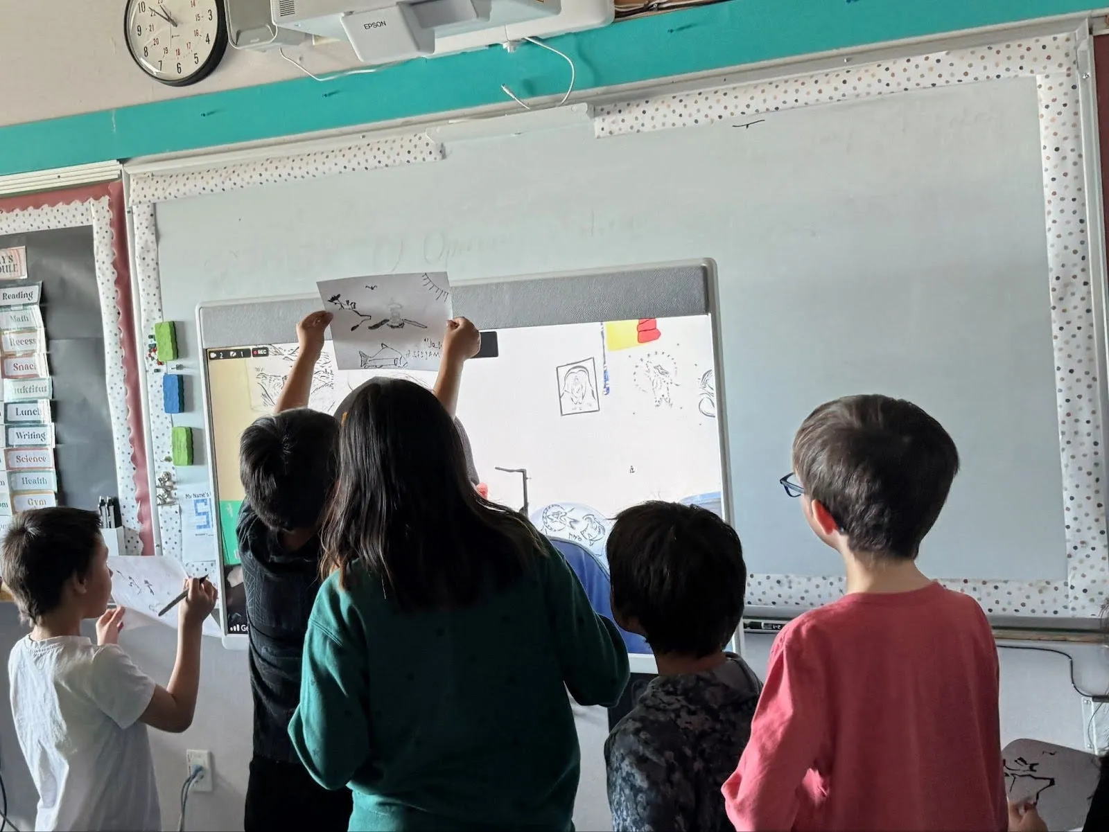 Students showing artwork to George