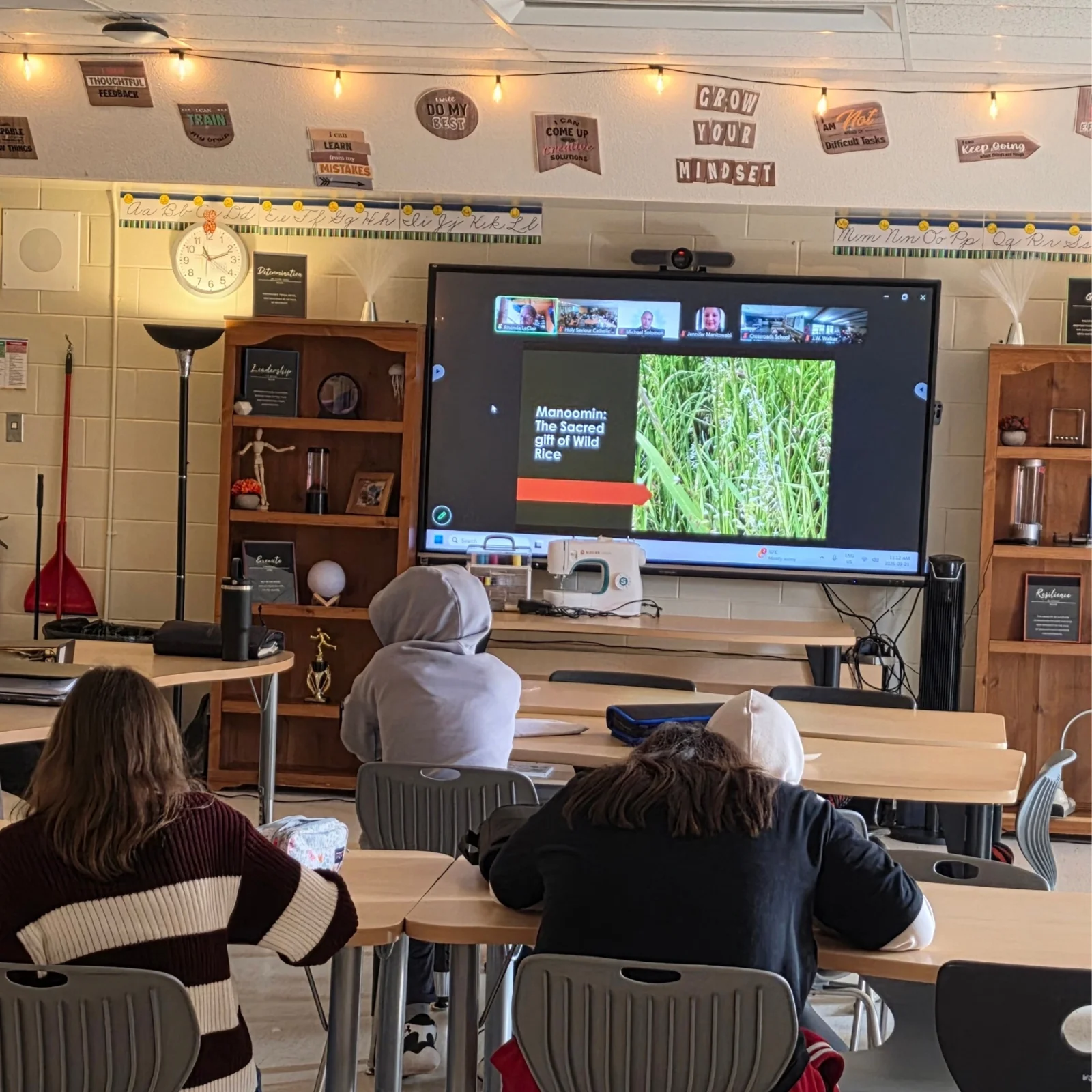 Students in a classroom watch a Connected North session about Manoomin, the sacred gift of wild rice.